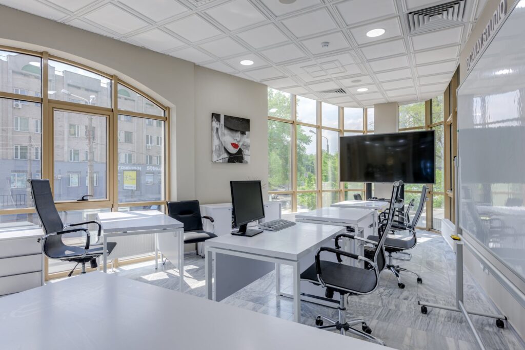 office interior design with black office rolling chairs and white tables