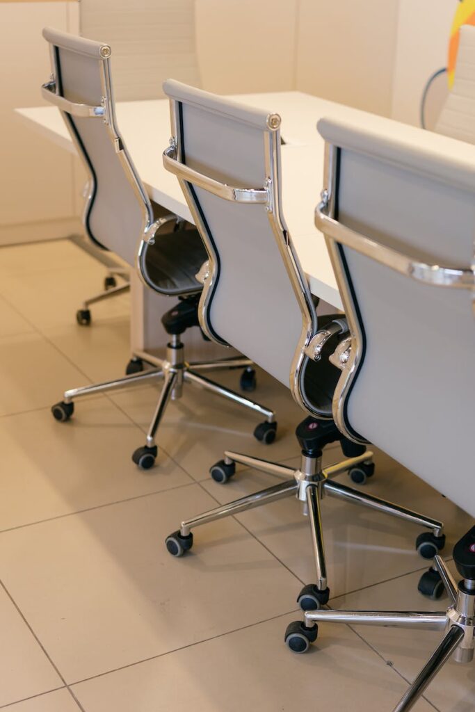 stainless steel framed office chairs at white table